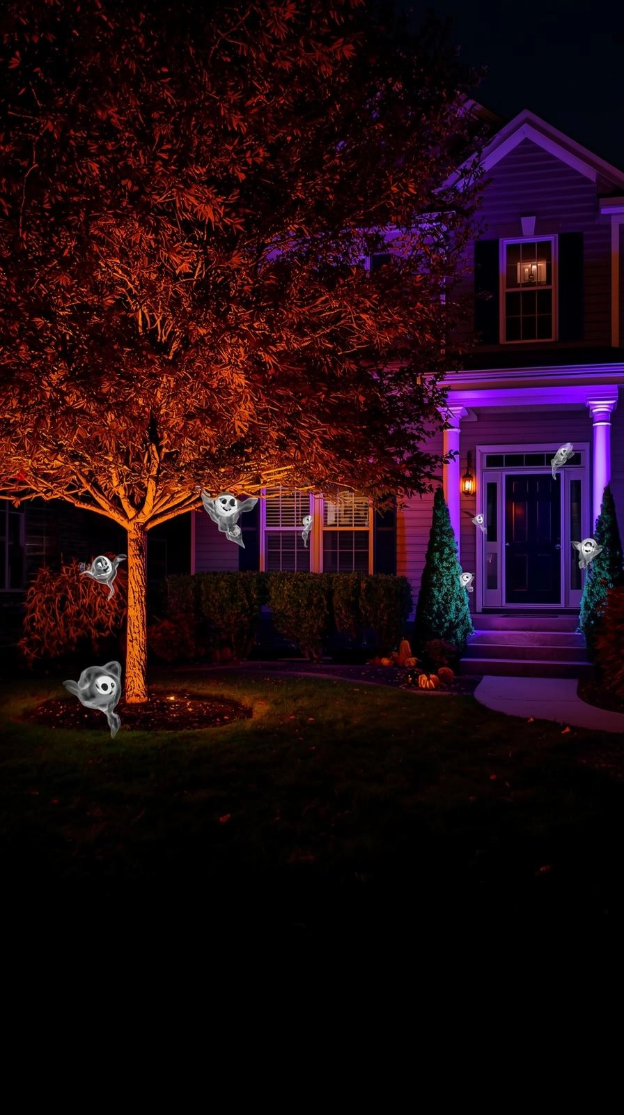 Halloween yard displays with orange and purple lights, ghost projections, and glowing eyes in a spooky front yard light show.